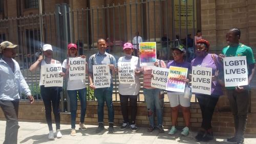 Activists protest outside a court