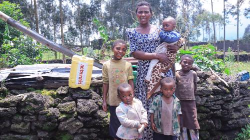 Furaha at home with her children.