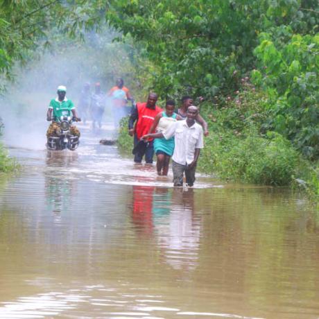 A photo of people wading through floodwater