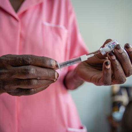 Nurse Margaret Kasolo gives an injection to a client at Kawala Health Center IV in Kampala, Uganda